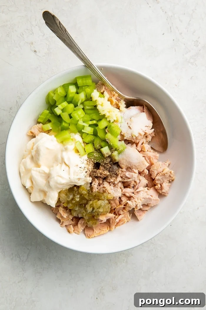 All the fresh ingredients for keto tuna salad perfectly combined in a mixing bowl, ready to be served.