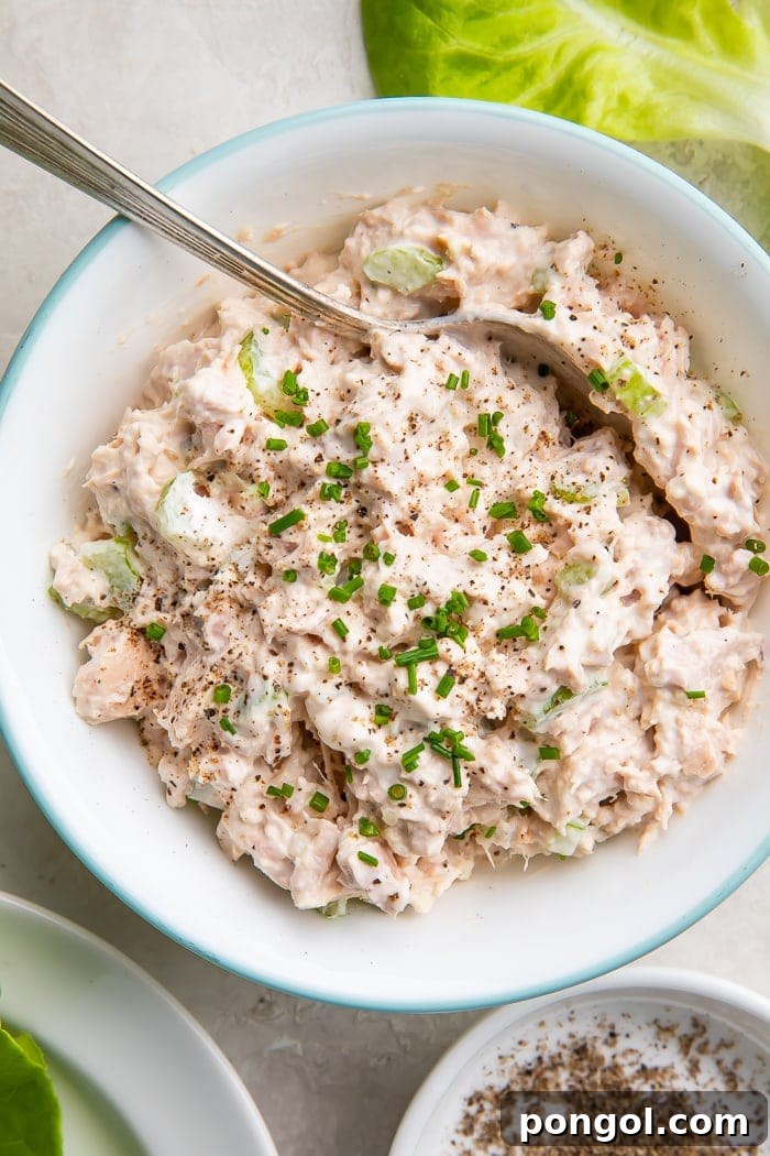 A bowl of creamy keto tuna salad with a spoon, ready to be enjoyed as a healthy and satisfying meal.