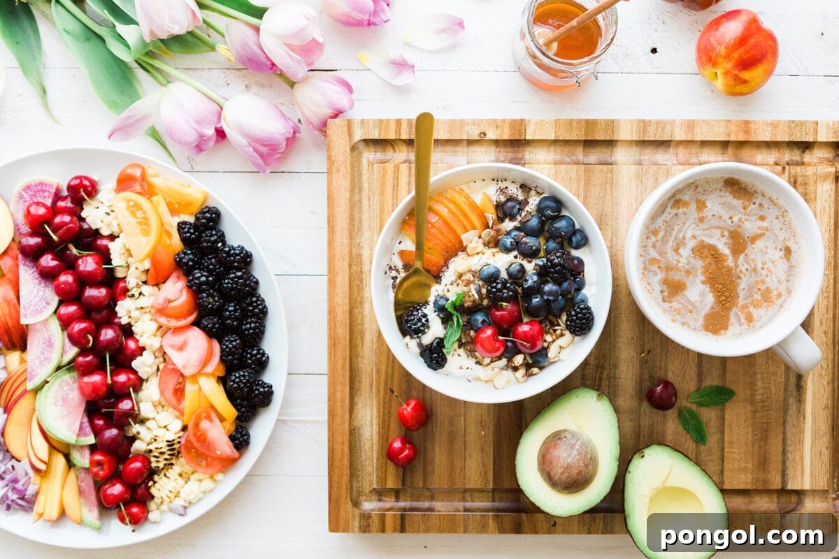 Finding My Light: A Natural Triumph Over Depression 5 A vibrant assortment of fresh fruits meticulously arranged on a plate, alongside an artfully prepared smoothie bowl adorned with additional fruit toppings and a soothing cup of tea. A picture of healthy eating.