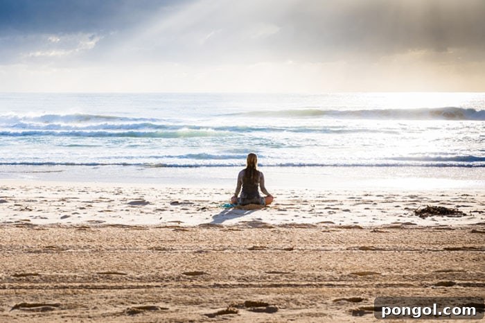 Finding My Light: A Natural Triumph Over Depression 9 A serene woman meditating on a tranquil beach, with the gentle ocean waves in the background, embodying peace and mindfulness.