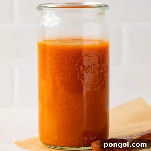 Homemade buffalo sauce in a small saucepan.