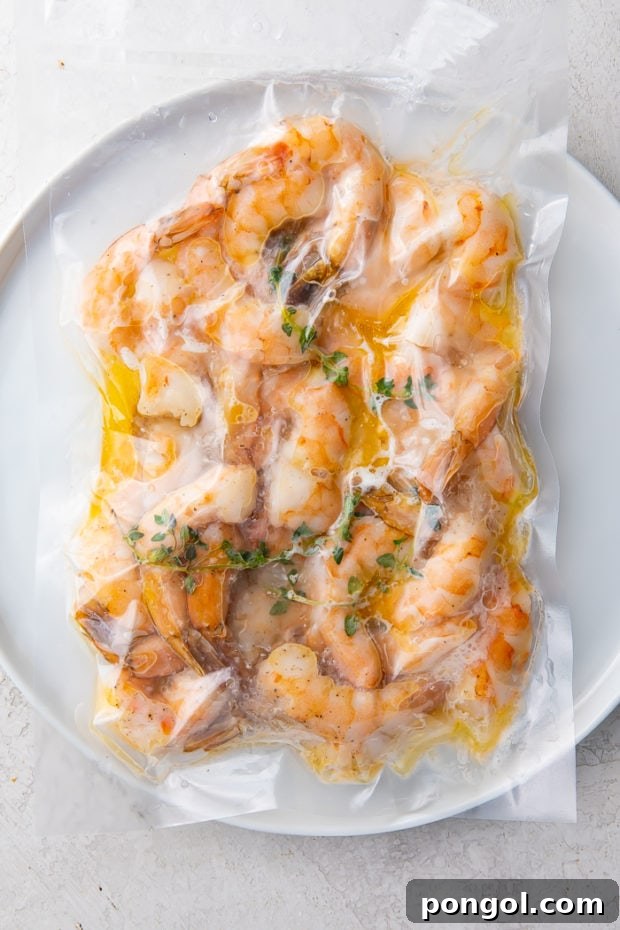 Cooked sous vide shrimp being seasoned