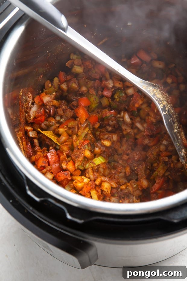 Ultimate Instant Pot Turkey Chili 7 Sautéing vegetables and adding spices for turkey chili