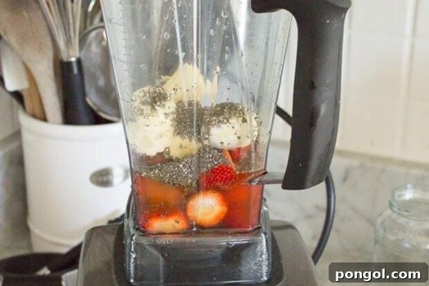 Flat tummy strawberry kombucha smoothie ingredients in a blender.