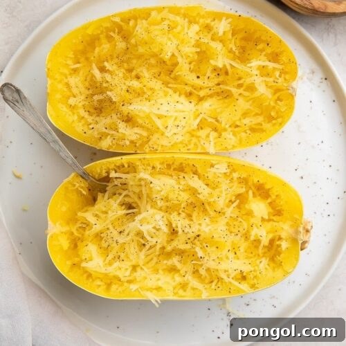 A beautifully cooked spaghetti squash, halved and ready to serve, representing the recipe.