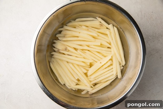 Step 2: Soaking potato sticks in water.