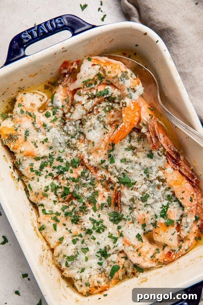 Golden Oven-Kissed Shrimp 2 Delicious baked shrimp served in a baking dish, garnished with fresh parsley.
