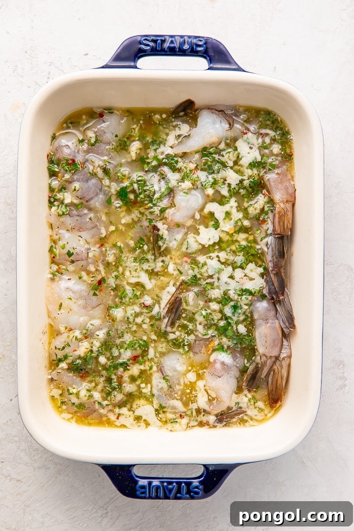 Golden Oven-Kissed Shrimp 4 Shrimp arranged in a baking dish, ready for the sauce.