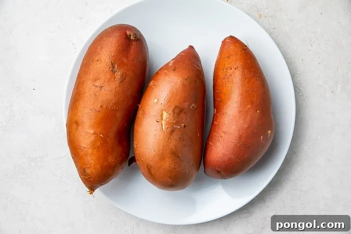 Three sweet potatoes on a white plate