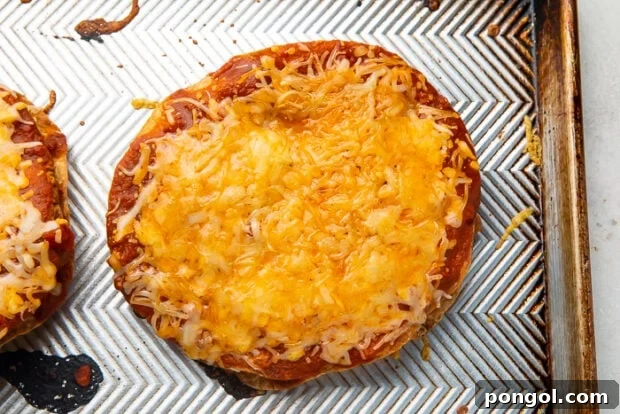 A cooked Taco Bell Mexican pizza with melted cheese sitting on top of a baking sheet
