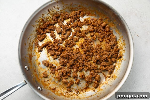 Ground beef being cooked in a skillet