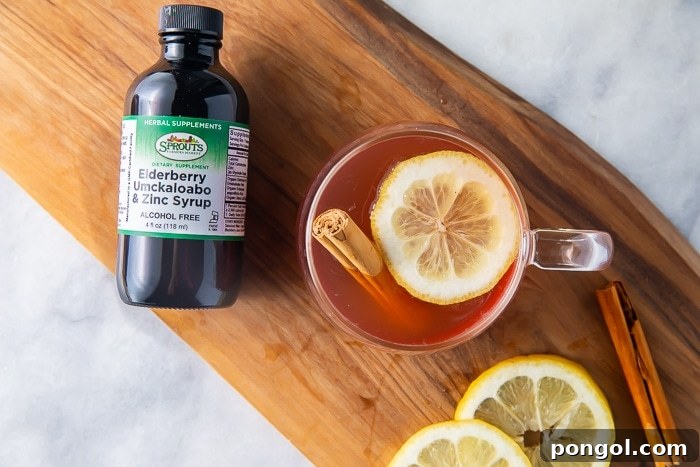 Ingredients for elderberry hot toddy cocktail on a wooden board
