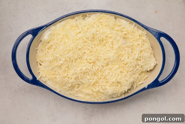 Cheesy Cauliflower Gratin 9 Step 4: Adding the remaining cheese layers and preparing the buttery breadcrumb topping in a separate bowl.