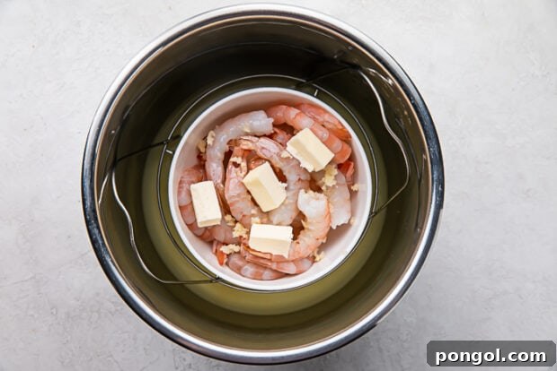 Shrimp, garlic, and butter in a ceramic bowl inside an Instant Pot.
