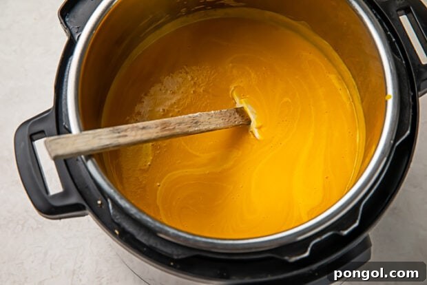 Butternut squash soup in a pot with cream