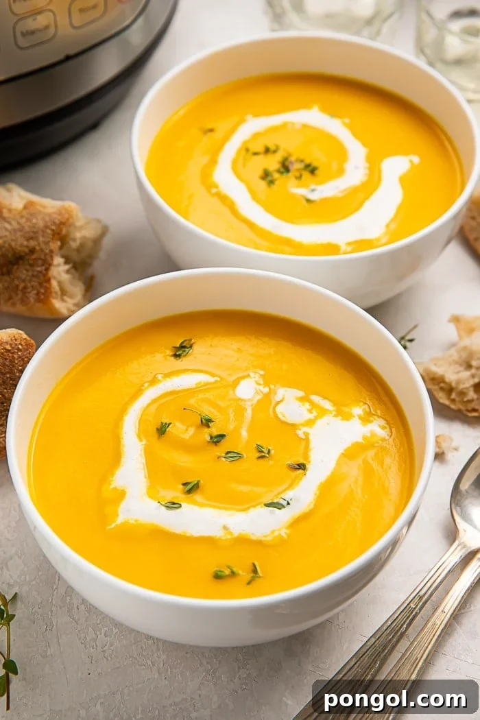 Two bowls of butternut squash soup next to spoons and an Instant Pot