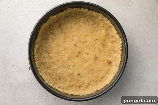 Preparing the almond flour crust for keto pumpkin cheesecake