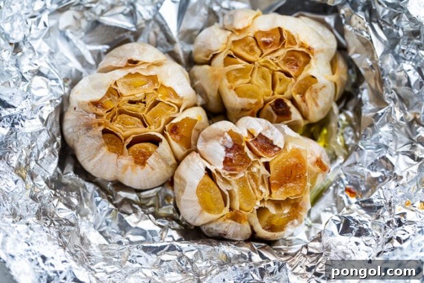 Mastering the Art of Roasting Garlic 6 Garlic heads drizzled with olive oil and wrapped in foil