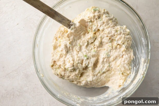 Mixing all crab rangoon dip ingredients in a bowl