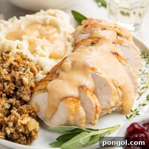 Instant Pot turkey breast slices covered with gravy on a plate