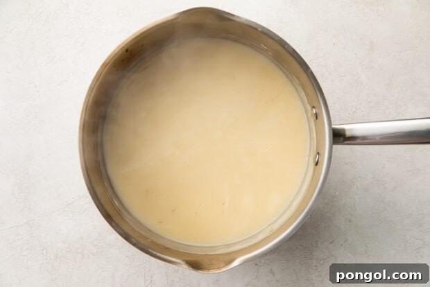 Step 3: Stirring in heavy cream and seasoning the finished gravy.