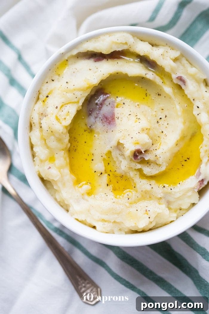 Stress-Free Thanksgiving: 19 Instant Pot Dishes 11 A bowl of creamy Whole30 Instant Pot mashed potatoes, garnished with fresh herbs, showcasing a rich and smooth texture, perfect for a healthy Thanksgiving option.