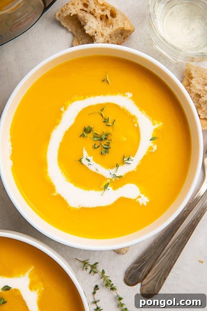 Stress-Free Thanksgiving: 19 Instant Pot Dishes 20 A creamy bowl of Instant Pot butternut squash soup, elegantly drizzled with cream and garnished, served in a white bowl, offering a comforting appetizer or side.