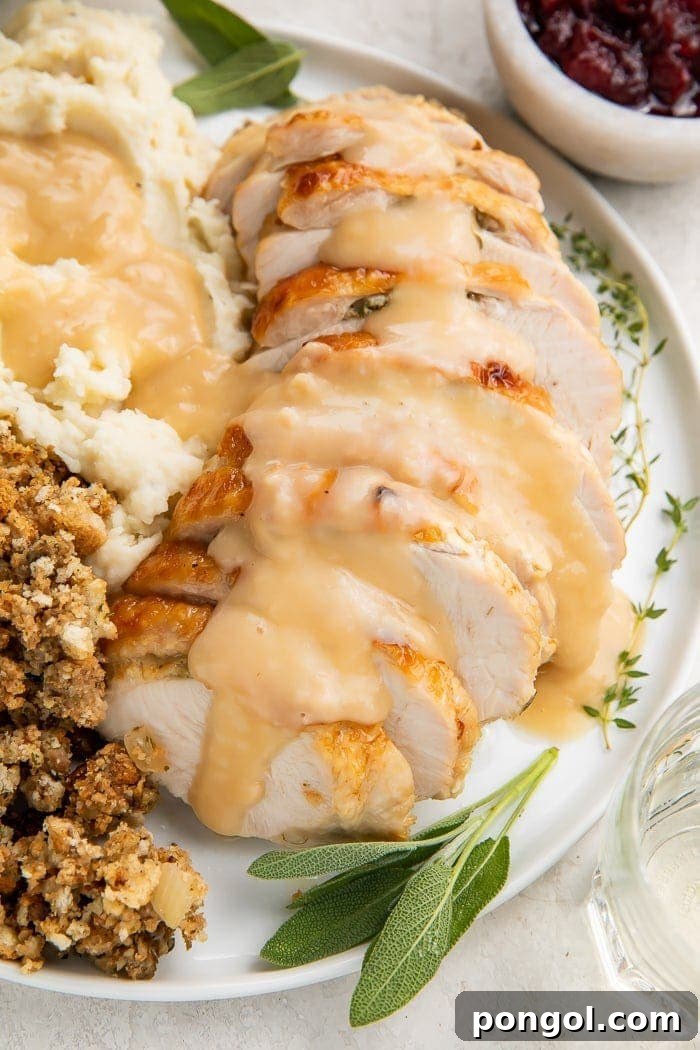 Stress-Free Thanksgiving: 19 Instant Pot Dishes 3 Slices of juicy Instant Pot turkey breast, glistening with savory gravy, served on a white plate, ready for a Thanksgiving dinner.