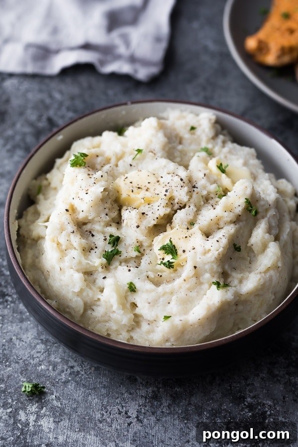 Stress-Free Thanksgiving: 19 Instant Pot Dishes 13 A bowl of creamy Instant Pot mashed cauliflower, garnished with fresh chives and a drizzle of butter, offering a low-carb alternative to mashed potatoes.