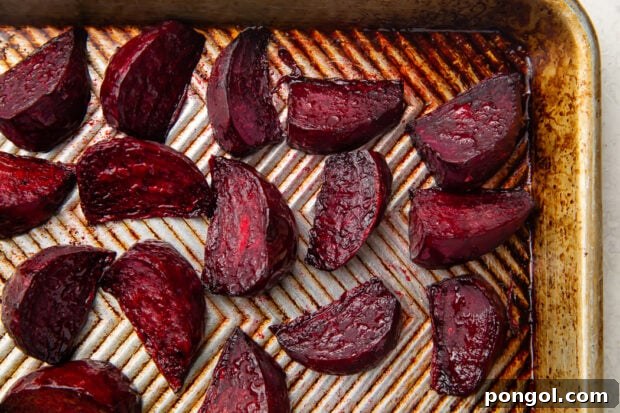Roasted beet wedges on silver sheet pan