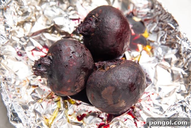 Whole roasted beets on sheet of aluminum foil