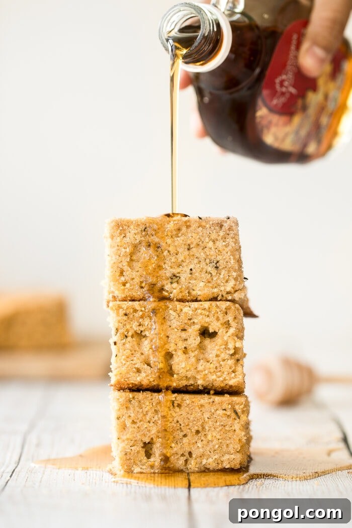 Stack of rosemary cornbread drizzled with glaze