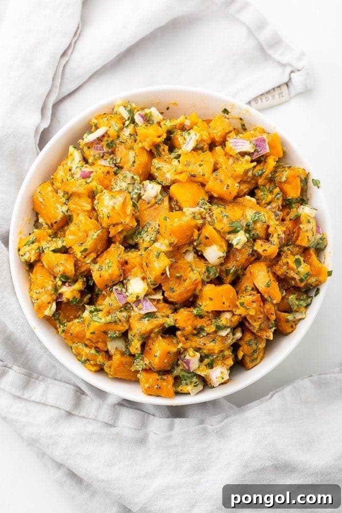 Sweet potato salad in a white bowl on a marble countertop