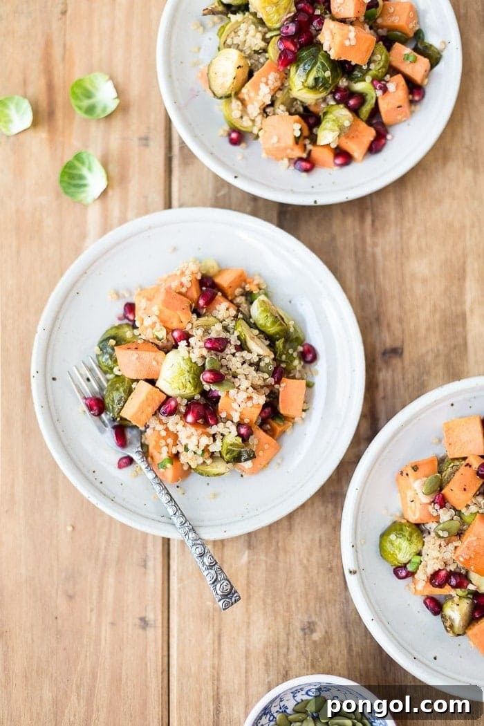 Wooden table top, white bowls, silver spoon, roasted brussel sprouts and sweet potatoes