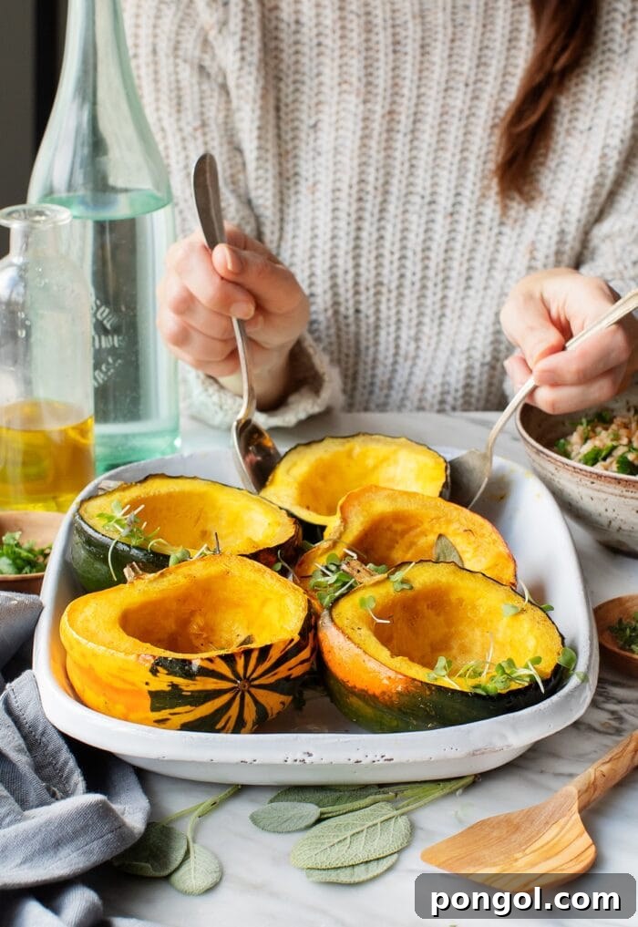 Woman wearing a neutral sweater holding serving utensils removing maple acorn squash from a white serving dish