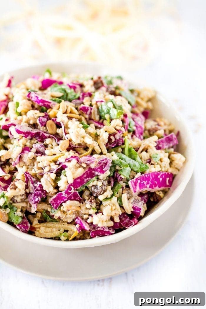 Spiralized apple slaw in a white bowl on a white background