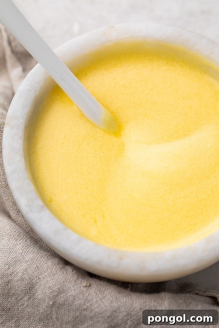 Quick Microwave Hollandaise 2 Buttery hollandaise sauce in a white ramekin dish, ready to serve