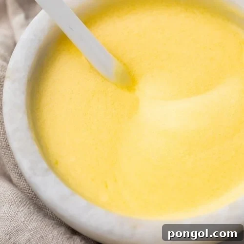 Buttery hollandaise sauce in a white ramekin dish