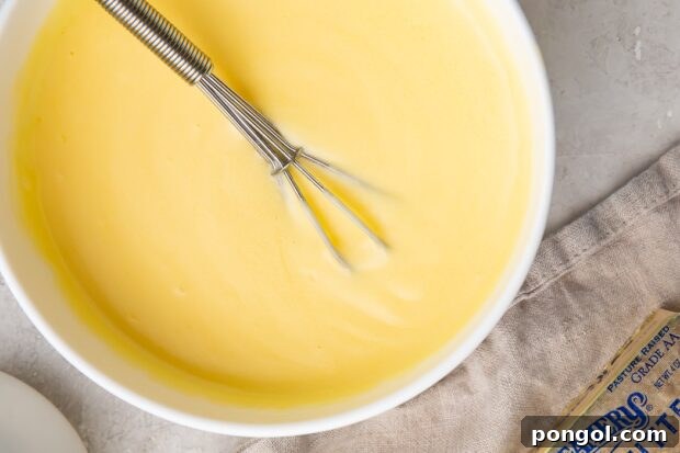 Quick Microwave Hollandaise 5 Microwave hollandaise sauce being stirred in a glass bowl
