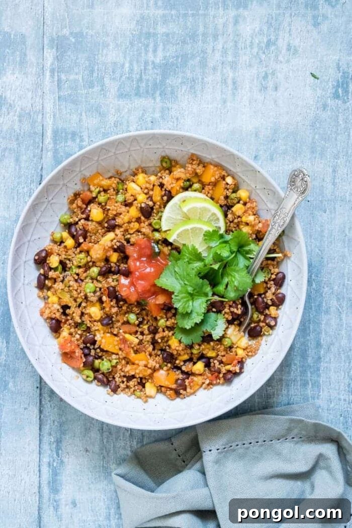 Instant Pot vegetarian Mexican quinoa in a white bowl against a blue background