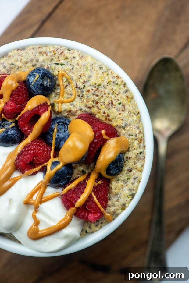 A vibrant Keto Oatmeal Breakfast Bowl topped with fresh fruit and whipped cream.