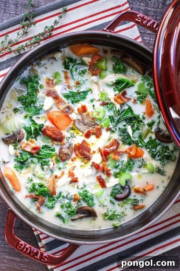 New Year, New You: 65 Satisfying Whole30 Meals 14 A large red pot filled with a rich and creamy chicken, kale, bacon, and veggie soup.