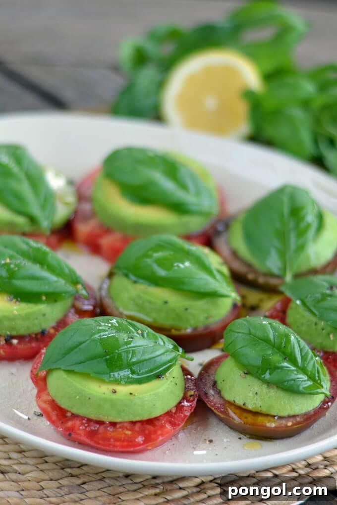 New Year, New You: 65 Satisfying Whole30 Meals 30 A white serving platter showcasing a fresh and vibrant tomato and avocado caprese.