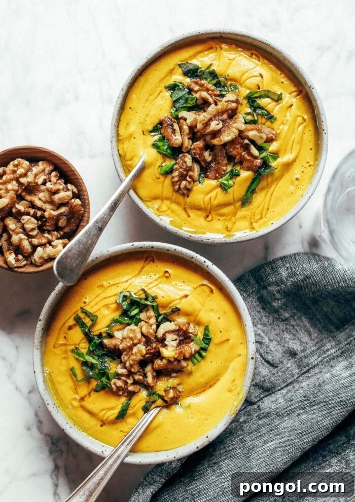 New Year, New You: 65 Satisfying Whole30 Meals 4 A bowl of vibrant golden turmeric vegetable soup, rich in flavor and nutrients.