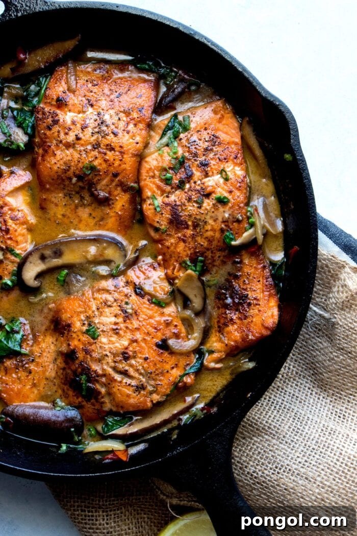New Year, New You: 65 Satisfying Whole30 Meals 62 A cast iron skillet showcasing beautifully braised salmon in a rich, creamy mushroom sauce.