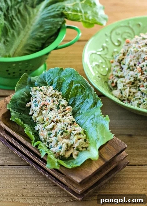 New Year, New You: 65 Satisfying Whole30 Meals 63 A scoop of tuna salad nestled in a crisp romaine lettuce leaf, presented on wooden trays.