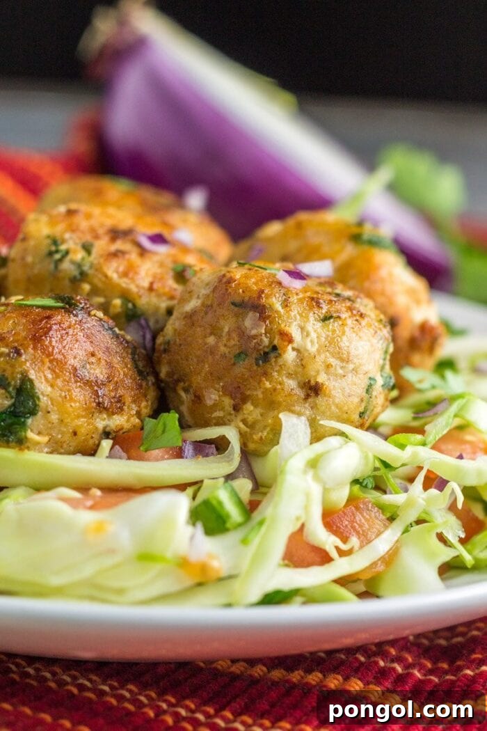 New Year, New You: 65 Satisfying Whole30 Meals 67 Flavorful fish taco balls served on a bed of fresh greens, offering a unique and healthy twist.