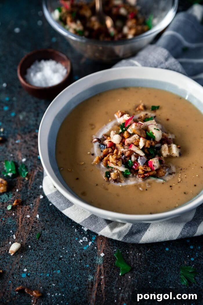 New Year, New You: 65 Satisfying Whole30 Meals 9 A white and blue bowl filled with dark, Moroccan spiced parsnip soup.