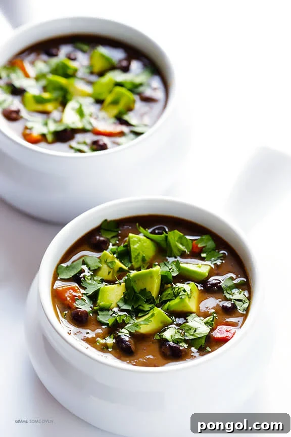 White bowls containing vegetarian slow cooker black bean soup