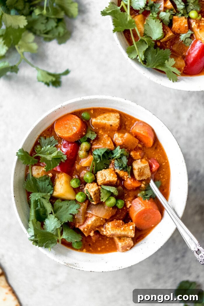 A white bowl of vegan tikka masala slow cooker stew